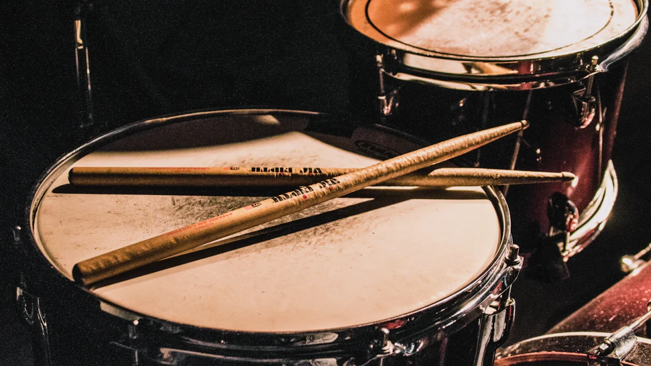 Drumsticks lying across a snare drum