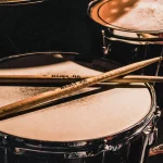 Drumsticks lying across a snare drum