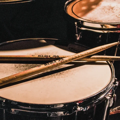 Drumsticks lying across a snare drum