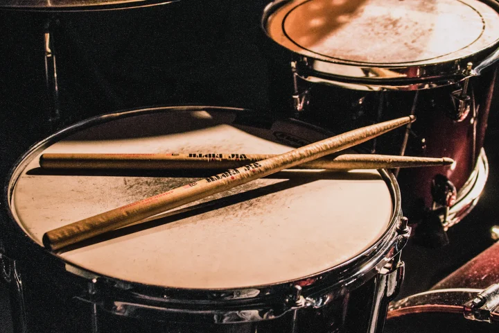 Drumsticks lying across a snare drum