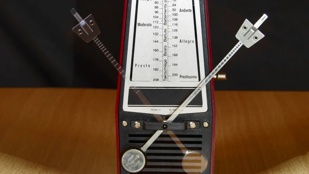 Close-up of a mechanical metronome with its pendulum in motion