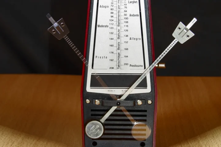 Close-up of a mechanical metronome with its pendulum in motion