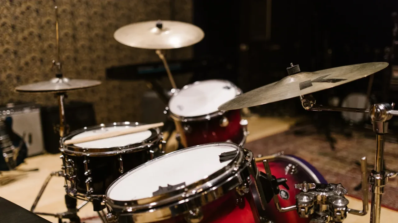 A red drum kit set up in a rehearsal studio