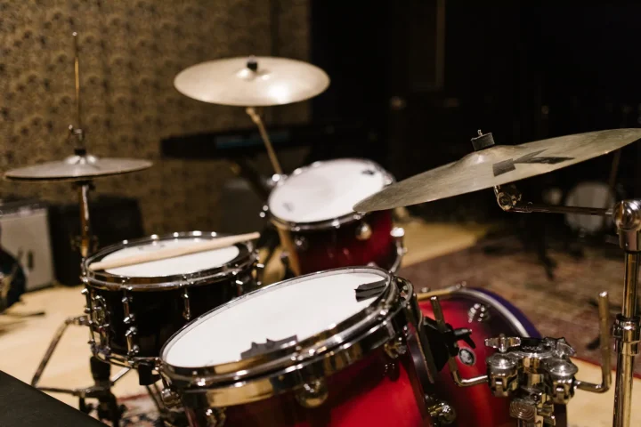 A red drum kit set up in a rehearsal studio